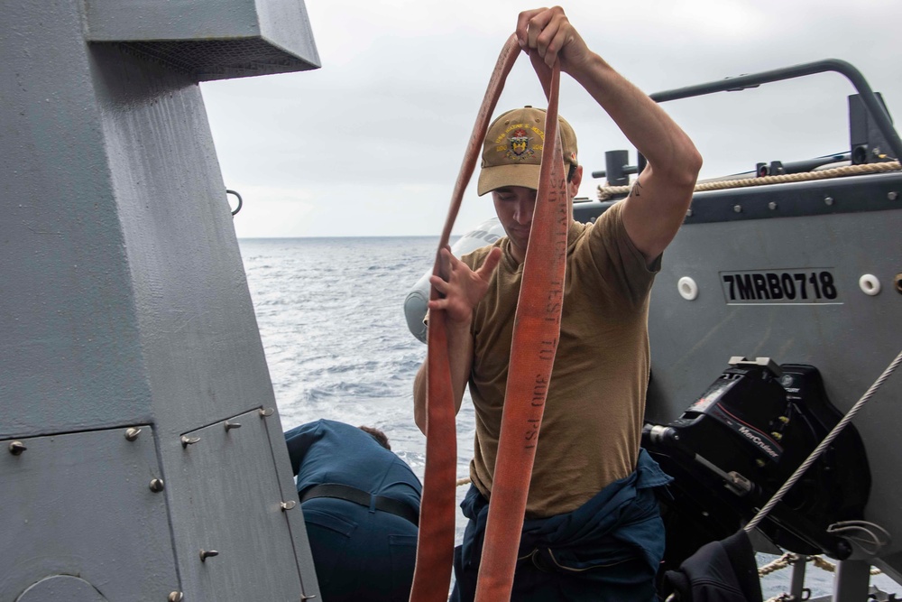 U.S. Sailor Stows Away A Fire Hose