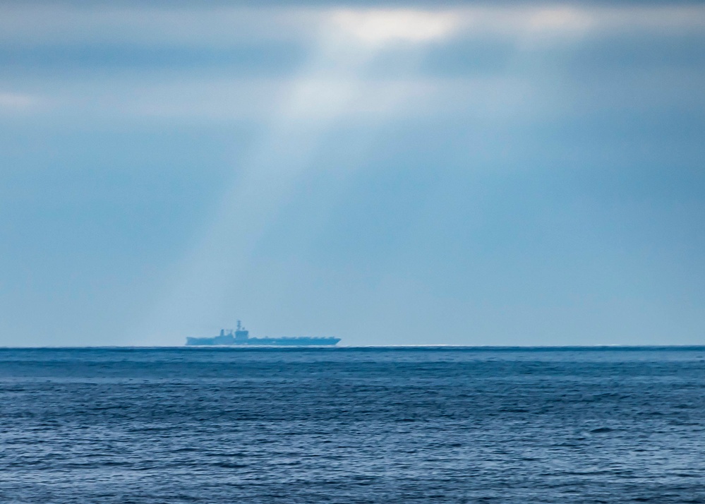 The Aircraft Carrier USS Nimitz (CVN 68) Steams Across The Horizon