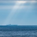 The Aircraft Carrier USS Nimitz (CVN 68) Steams Across The Horizon