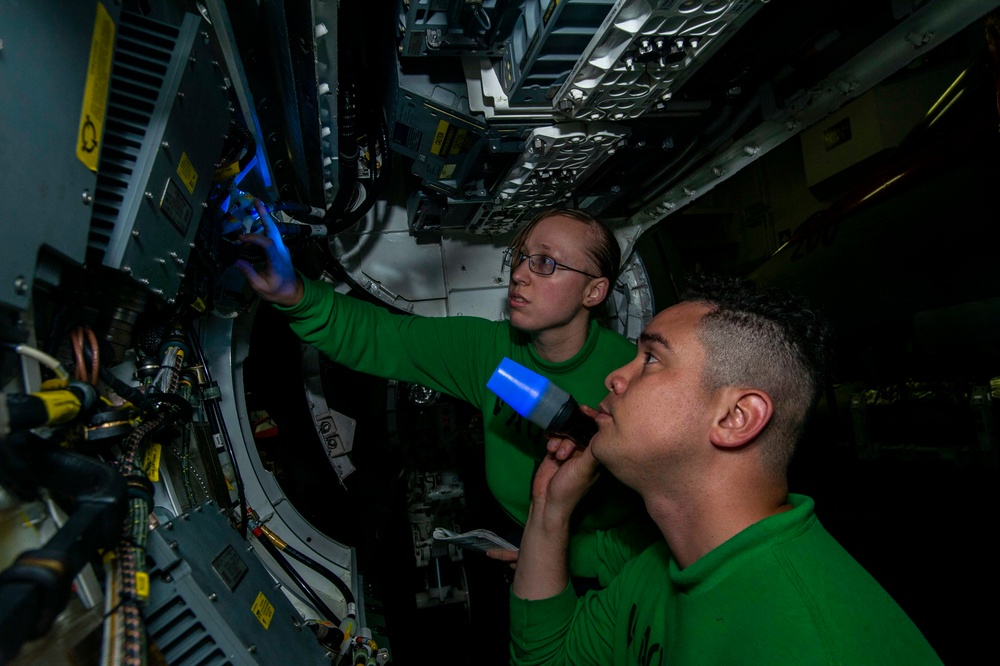 Sailors Perform Cavity Inspection On An Aircraft