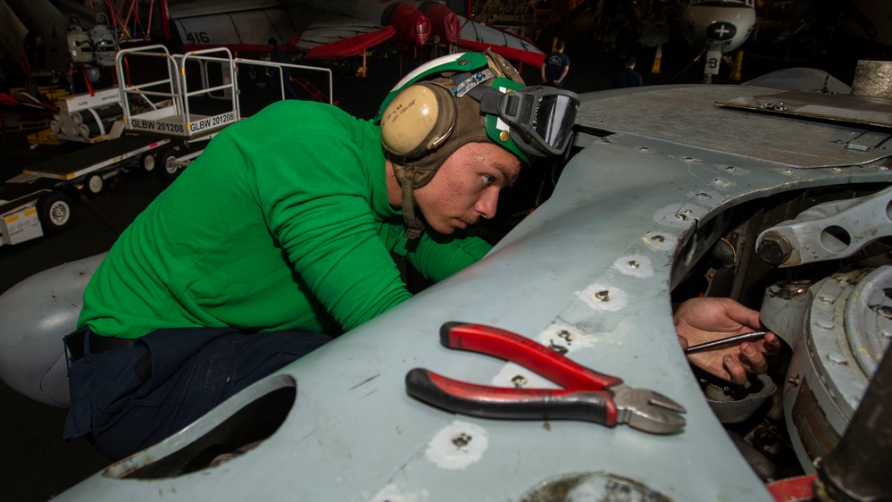 Sailor Performs Phase Maintainence On An Aircraft