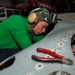 Sailor Performs Phase Maintainence On An Aircraft