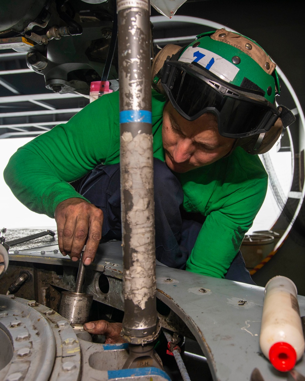 Sailor Performs Phase Maintainence On An Aircraft