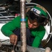 Sailor Performs Phase Maintainence On An Aircraft