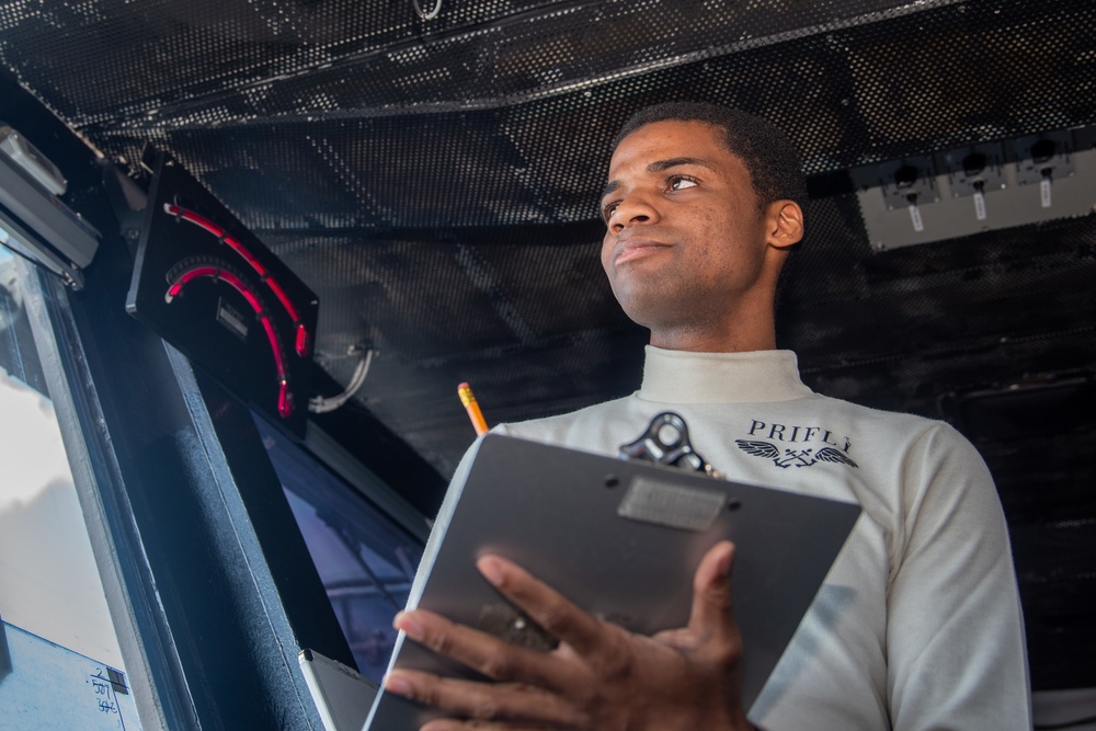 USS Ronald Reagan (CVN 76) Sailors in Primary Flight Control and below decks