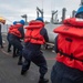 U.S. Sailors Heave The Line During An Underway Replenishment