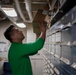 U.S. Navy Sailor Restocks Aircraft Parts