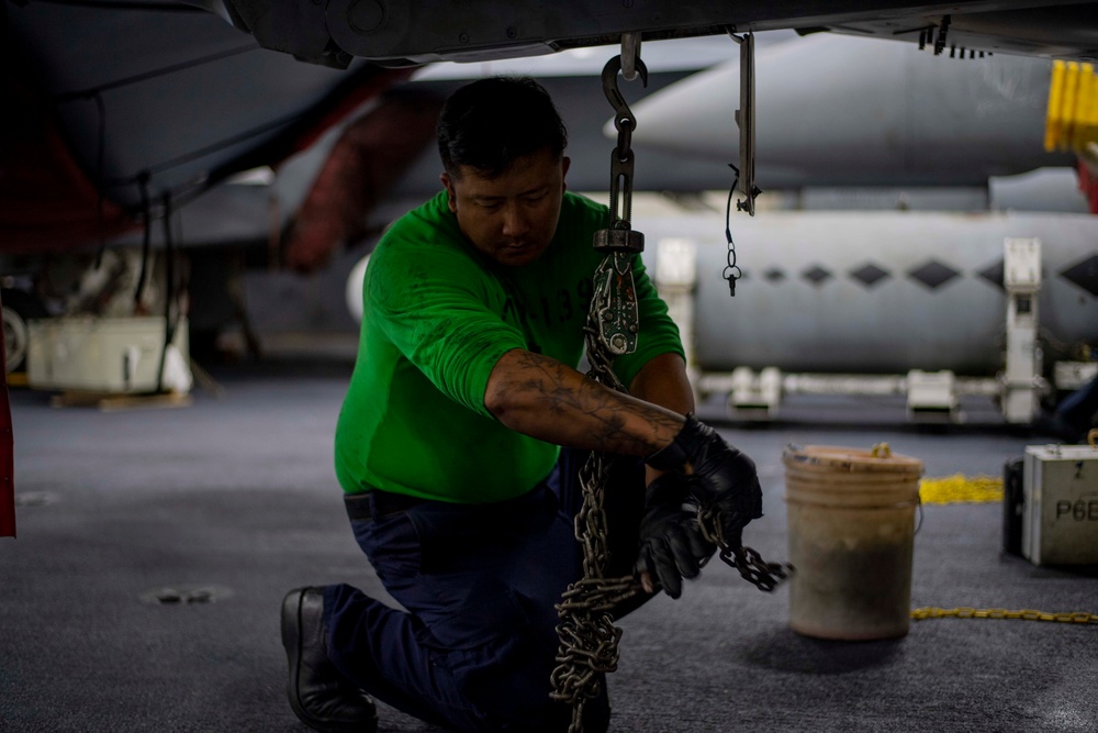 U.S. Navy Sailor Chains Down Aircraft