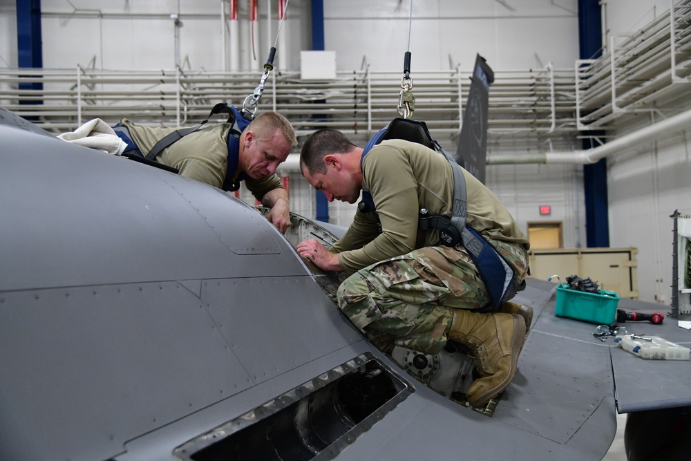 Aircraft Armament Systems specialists remove gun