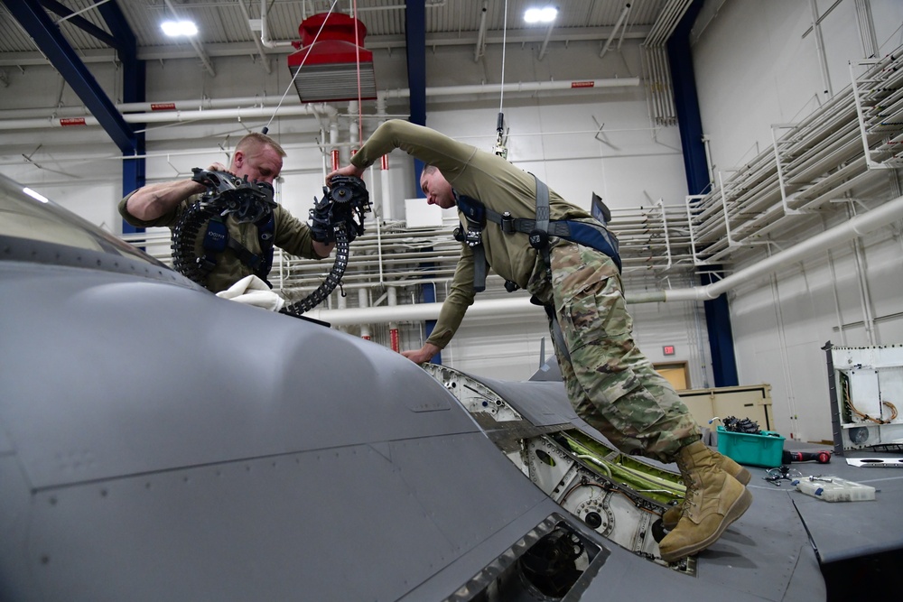 Aircraft Armament Systems specialists remove gun