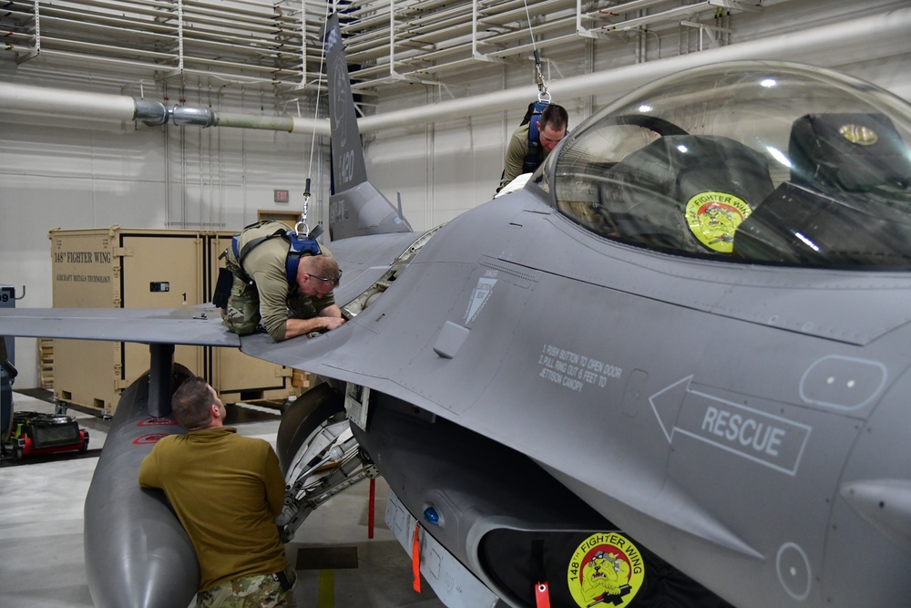 Aircraft Armament Systems specialists remove gun