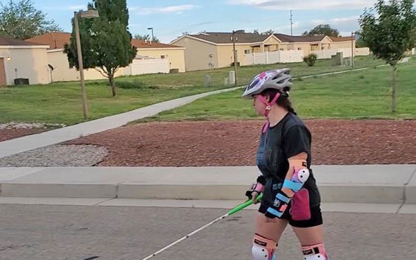 Meagan Gorsuch riding OneWheel with assistive technology