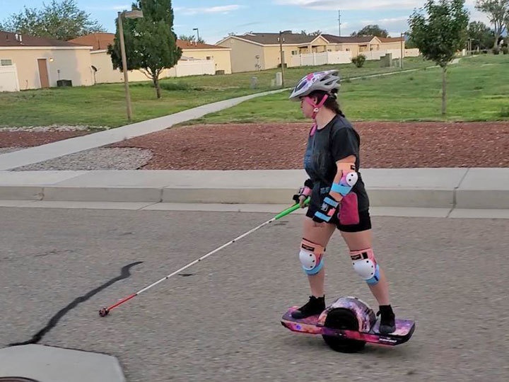 Meagan Gorsuch riding OneWheel with assistive technology