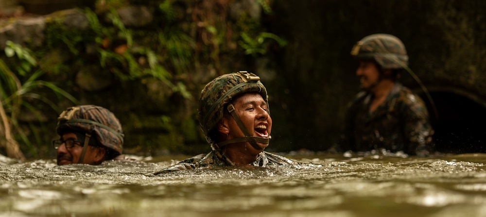 Marines tread through the jungle of Okinawa during The Jungle Warfare Training Course.