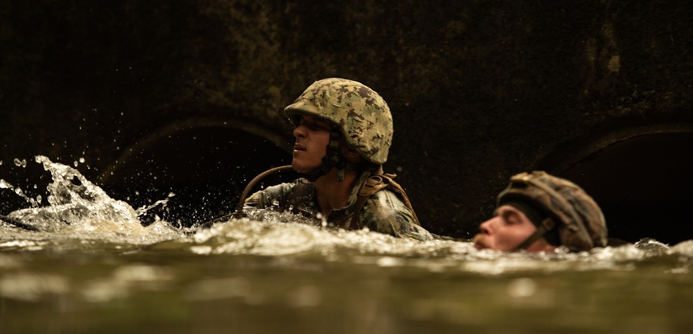 Seabees with Naval Mobile Construction Battalion 4, join Marines in the Jungle Warfare Training in Okinawa, Japan.