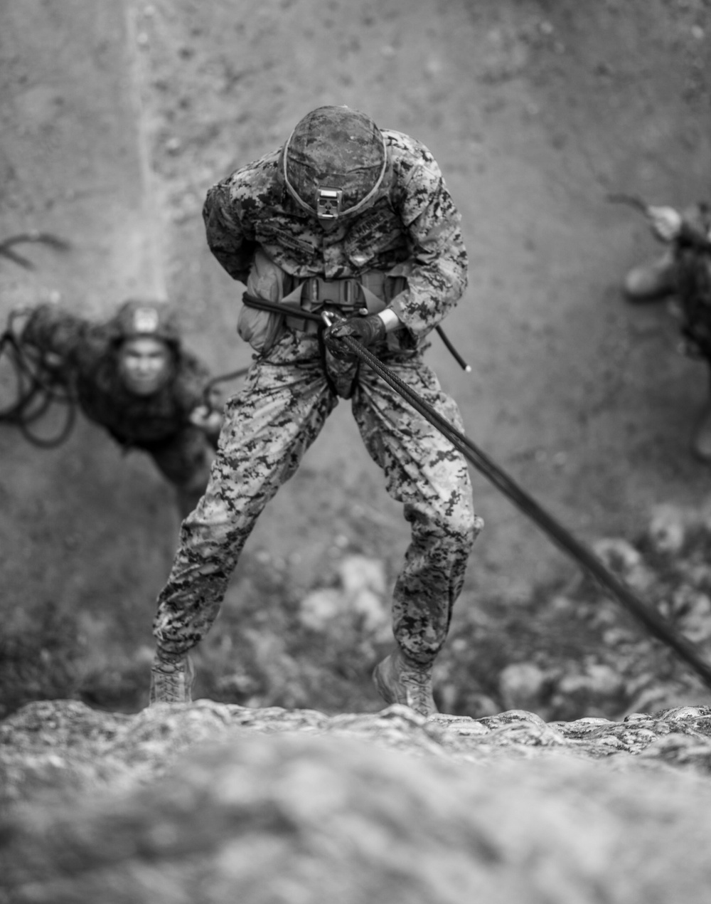 Marines repel down a cliff side during The Jungle Warfare Training Course.