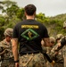 Seabees and Marines prepare to cross rope bridges during Jungle Warfare Training.