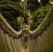 Seabees cross rope bridge during Jungle Warfare Training.