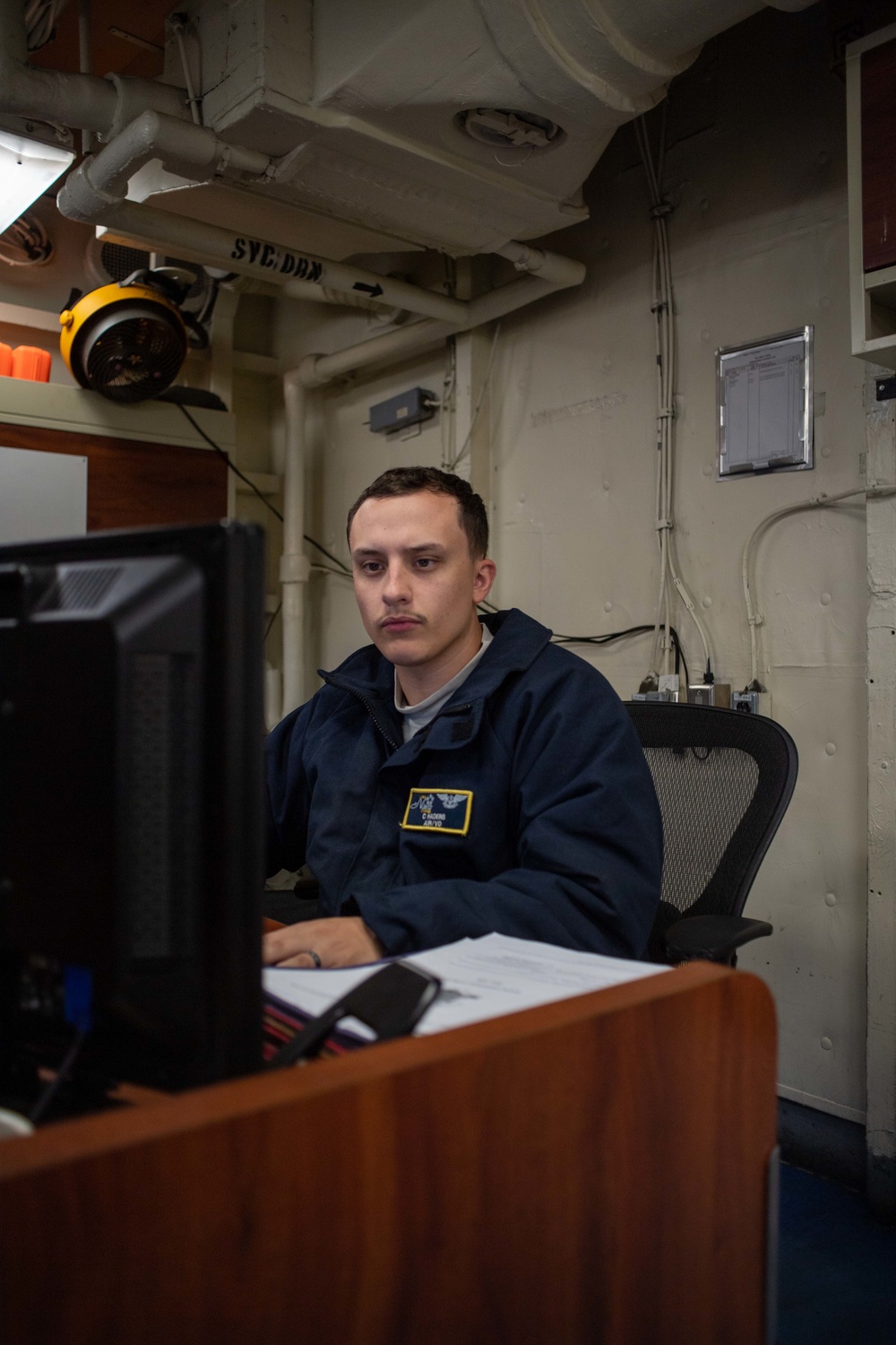 U.S. Navy Sailor Completes Paper Work