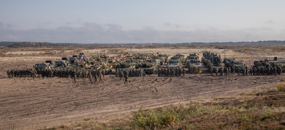 U.S. and Polish Armies maneuver tanks during live fire in Nowa Deba