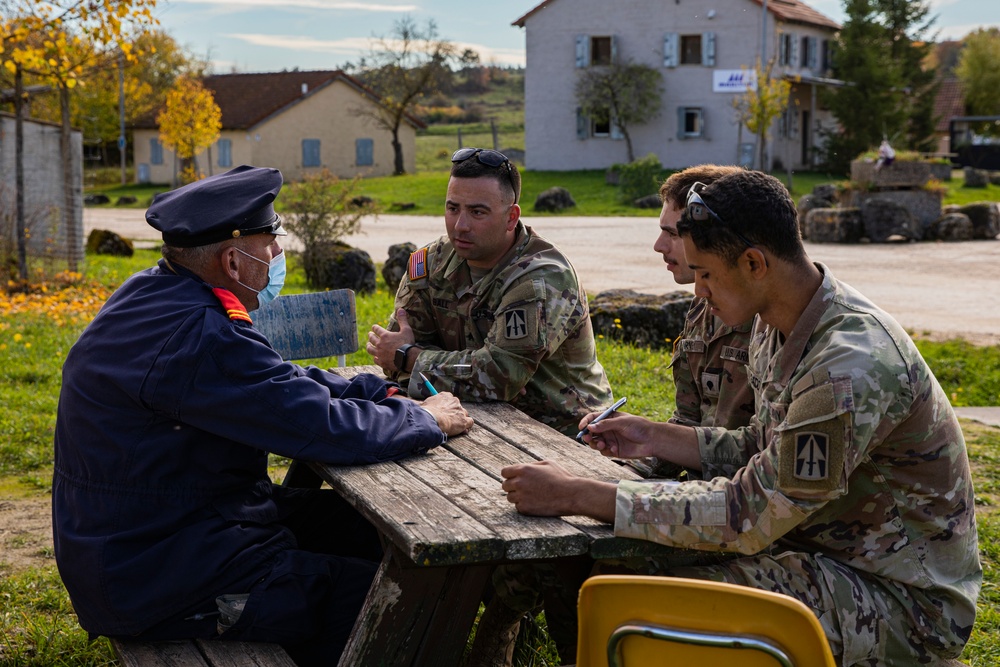 Liaison Monitoring Teams meet with actors for training exercise