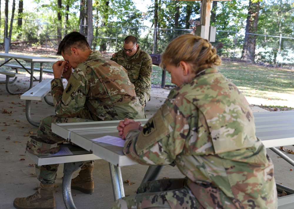 412th TEC Soldiers Pray during Religious Services
