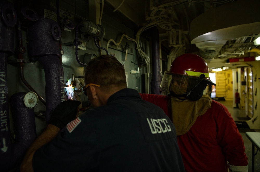 Coast Guard Cutter Hamliton crewmembers repair refrigerator while underway in the Atlantic Ocean