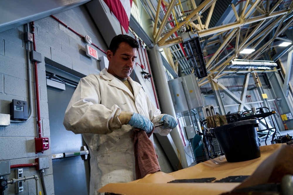 Maintainer cleans KC-135 engine parts