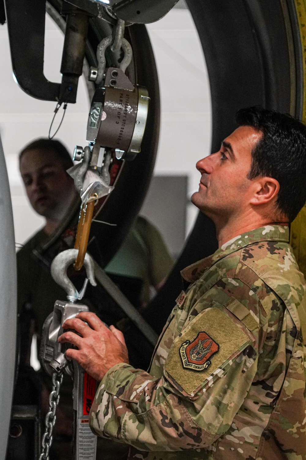 Aircraft maintainer inspects engine weight scale