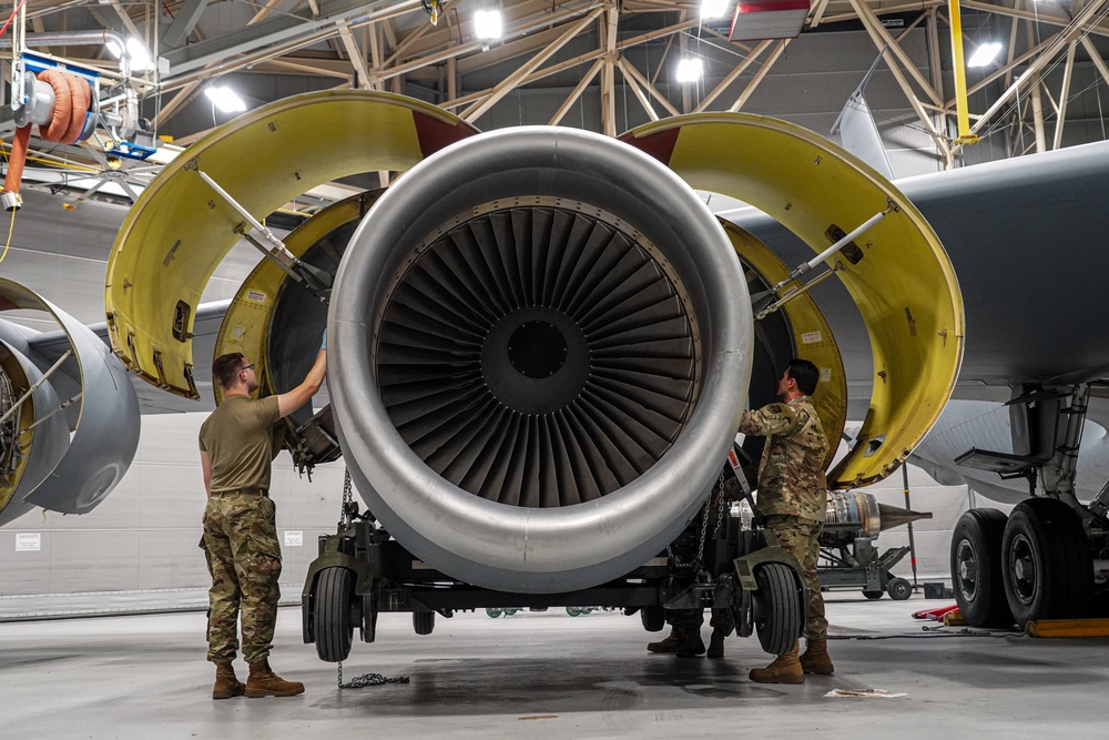 KC-135 engine being lifted into place