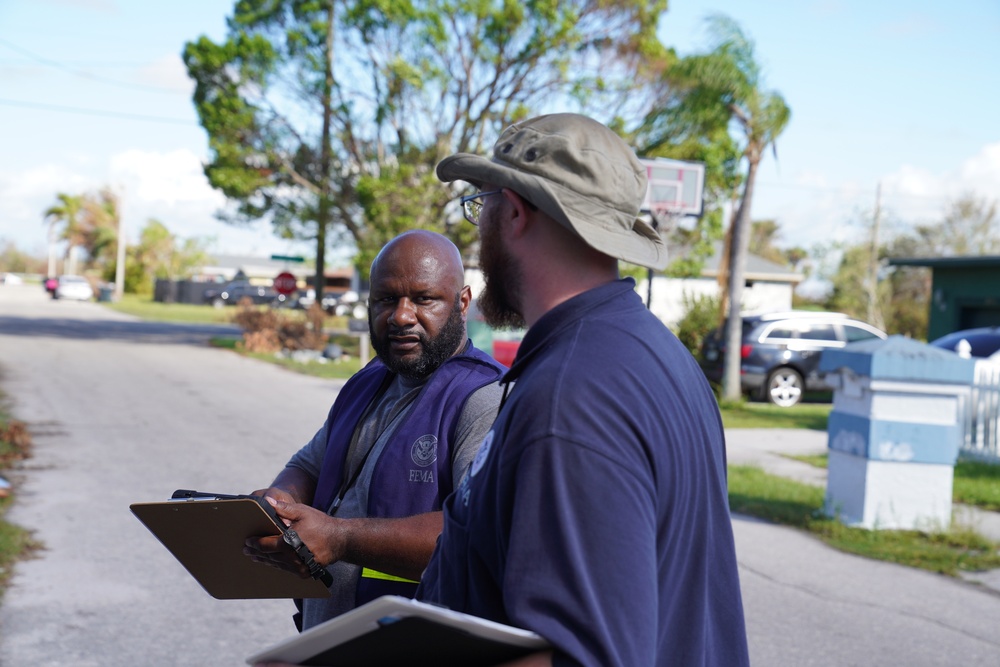 A FEMA Disaster Survivor Assistance Team Goes Door to Door Registering Survivors for Disaster Relief