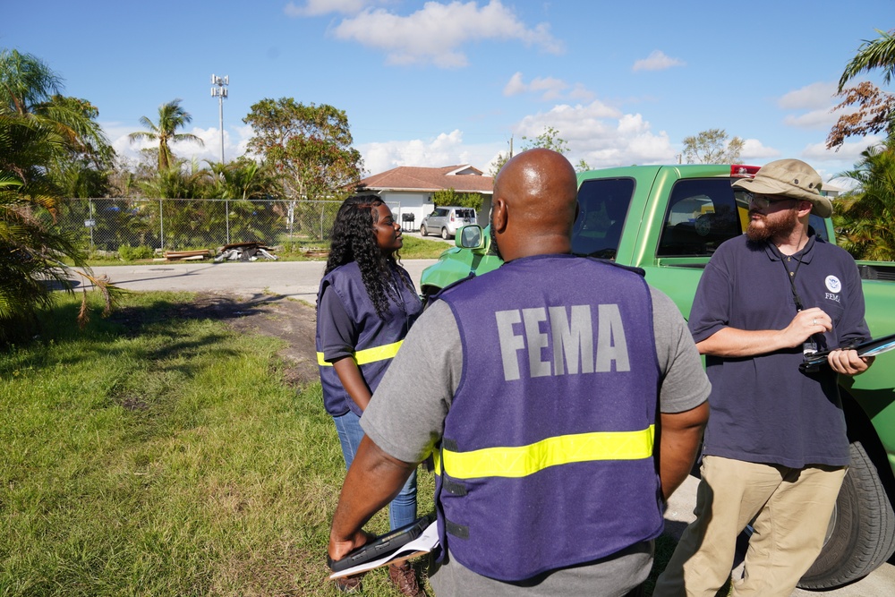 A FEMA Disaster Survivor Assistance Team Goes Door to Door Registering Survivors for Disaster Relief