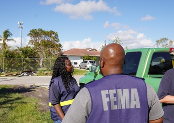 A FEMA Disaster Survivor Assistance Team Goes Door to Door Registering Survivors for Disaster Relief
