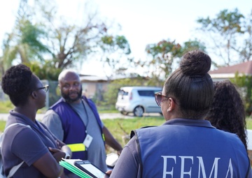 A FEMA Disaster Survivor Assistance Team Goes Door to Door Registering Survivors for Disaster Relief