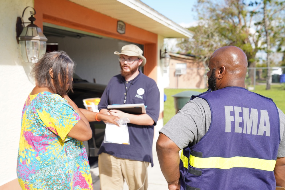FEMA Disaster Survivor Assistance Team Speak to Survivor with Roof Damage