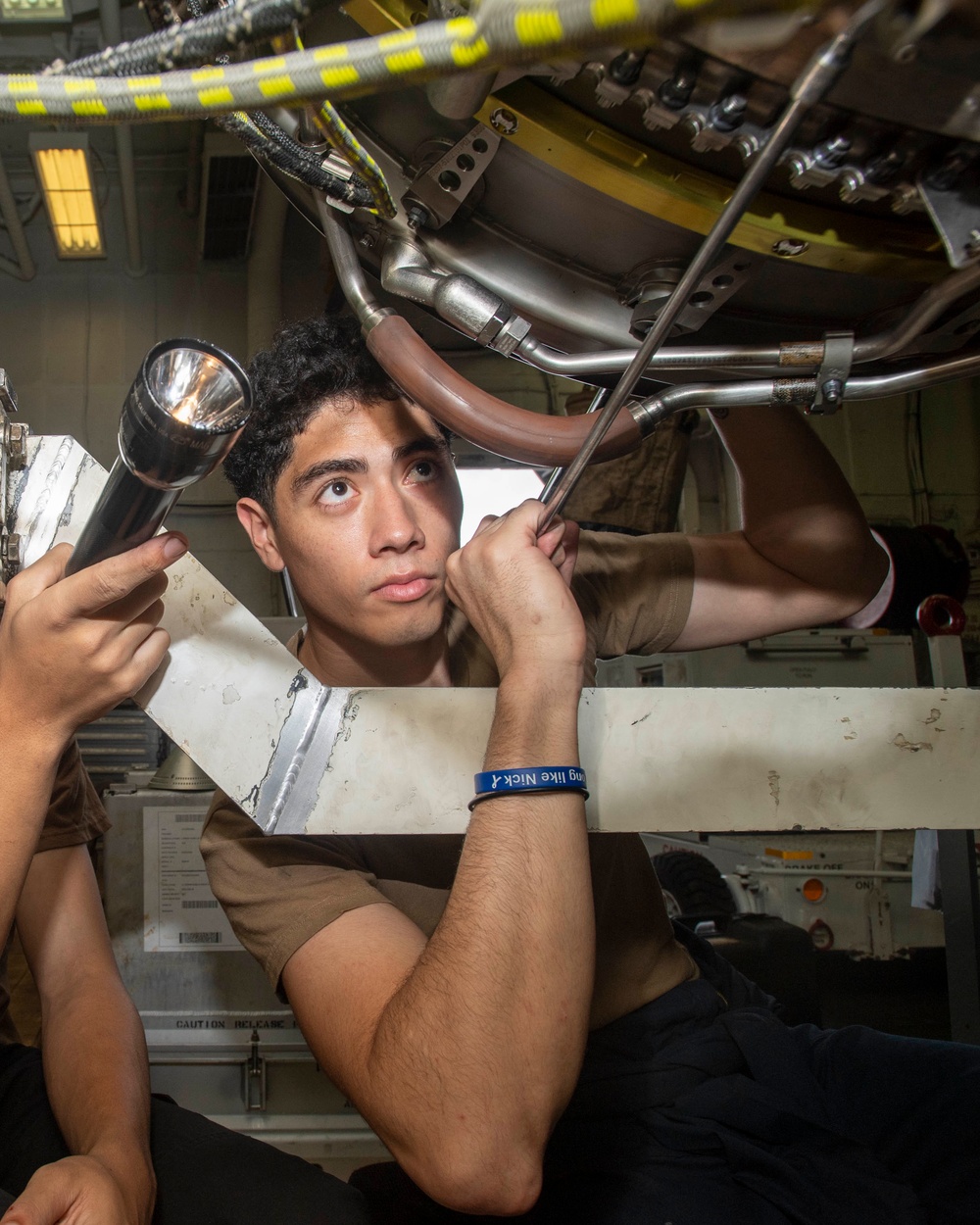 Sailor Removes Bolts From Engine