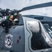 U.S. Sailor Performs Maintenance On An MH-60R Sea Hawk Helicopter