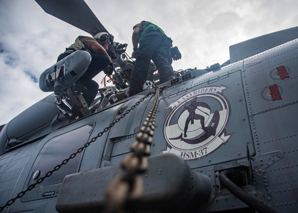 U.S. Sailors Perform Maintenance On An MH-60R Sea Hawk Helicopter