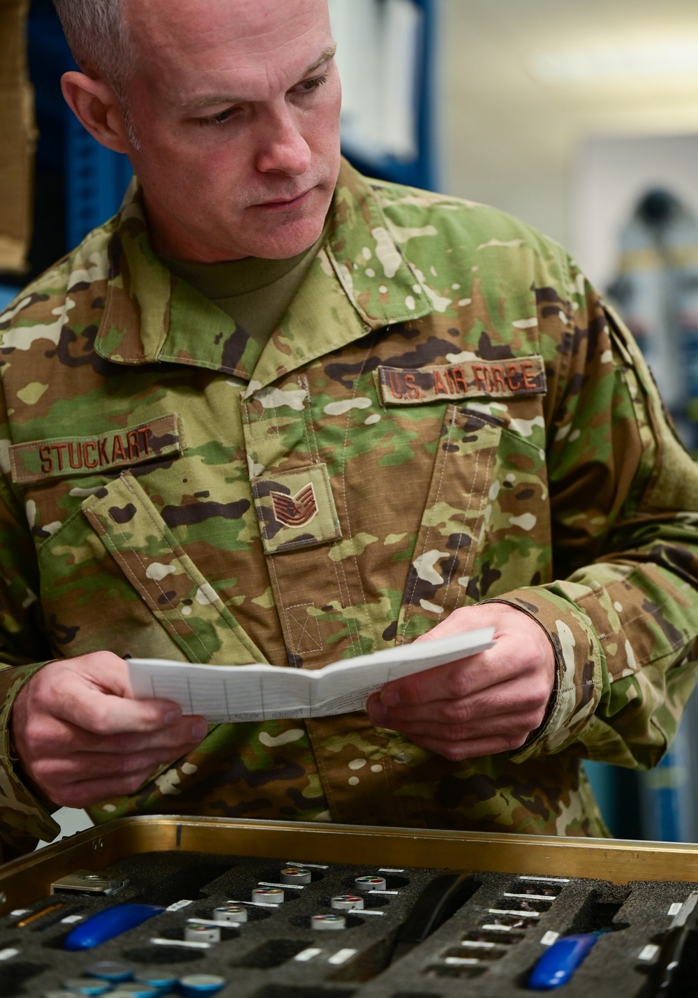 Photo of U.S. Air Force Tech. Sgt. Kurt Stuckart performing an annual inventory and inspection on a pin removal and insertion kit