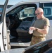Photo of U.S. Air Force Tech. Sgt. Michael Moody installing a vehicle analytics device