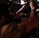 U.S. Sailor Performs Maintenance On An MH-60R Sea Hawk Helicopter