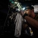 U.S. Sailor Performs Maintenance On An MH-60R Sea Hawk Helicopter