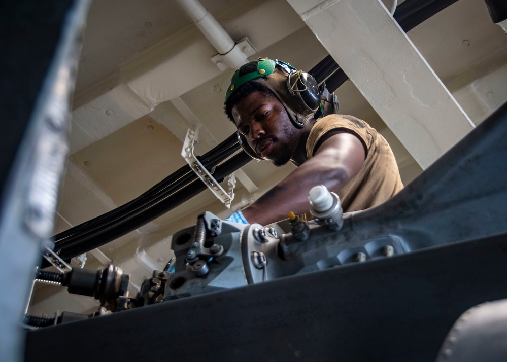 U.S. Sailor Performs Maintenance On An MH-60R Sea Hawk Helicopter