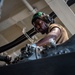 U.S. Sailor Performs Maintenance On An MH-60R Sea Hawk Helicopter