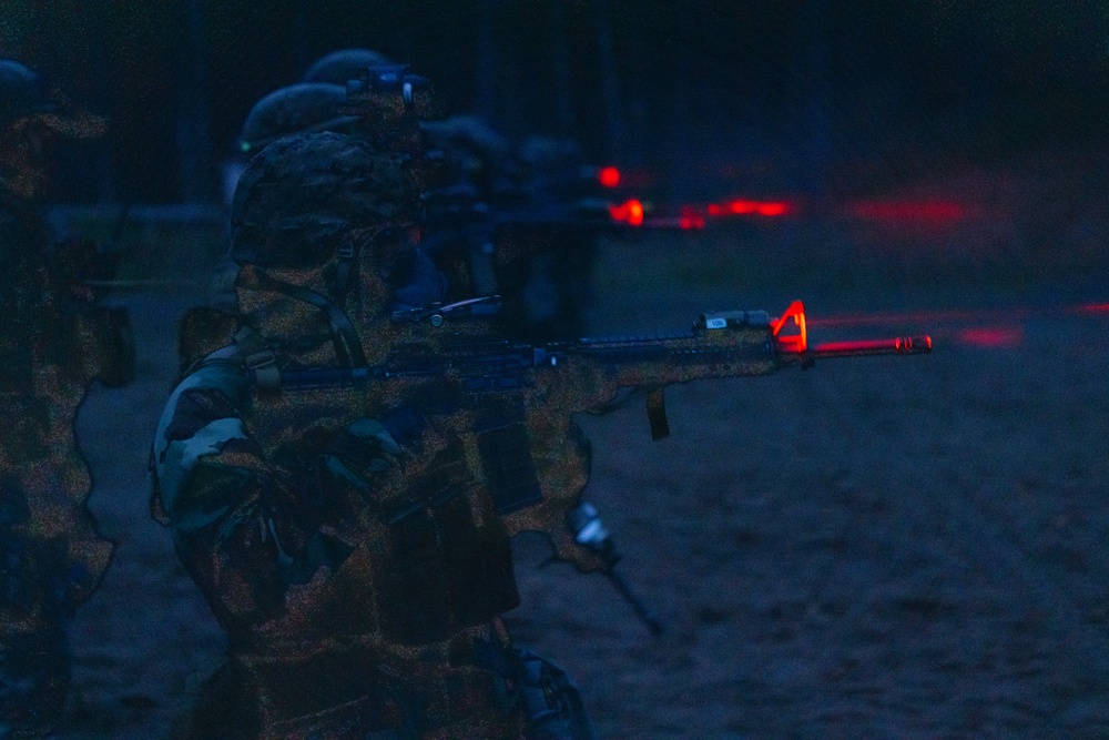 U.S. Marines conduct night time operations in Mission Oriented Protective Posture (MOPP) gear
