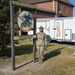 Photo of 116th Services Airman by disaster relief mobile kitchen trailer