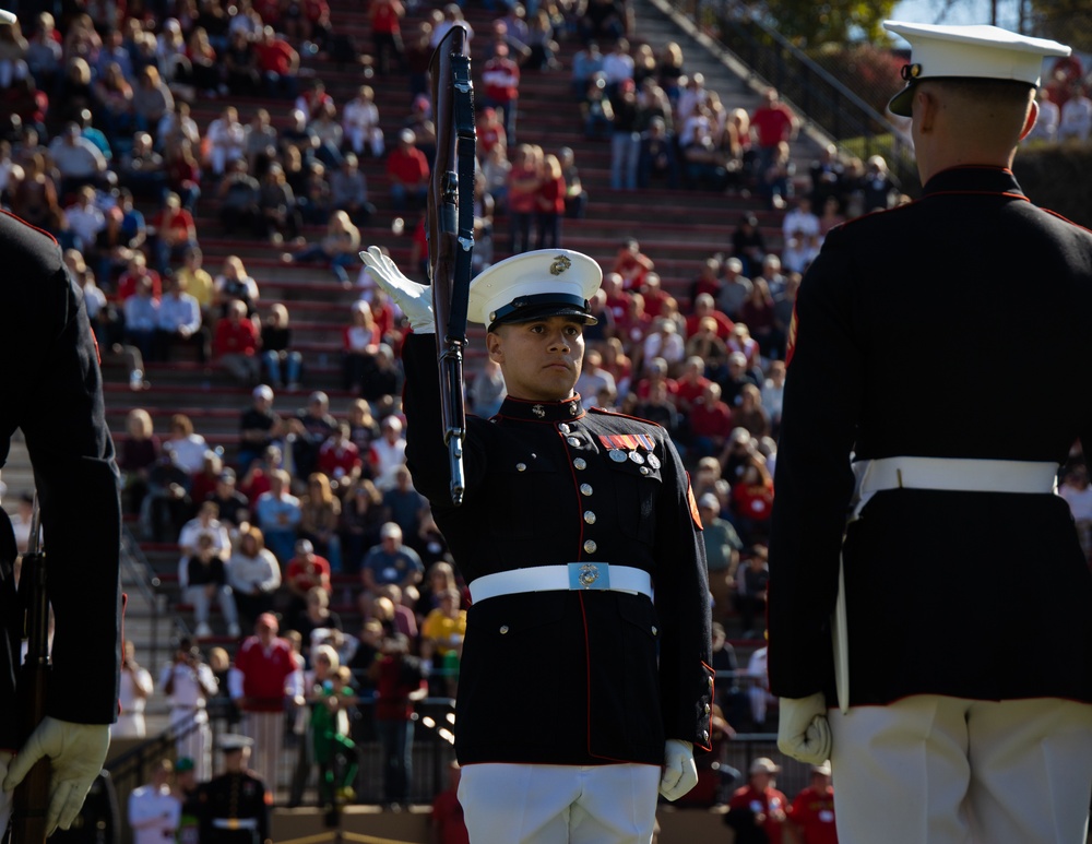 Marines with “The Silent Drill Platoon,” Marine Barracks Washington, perform for thousands of cadets and family members, during a Virginia Military Institute football game.