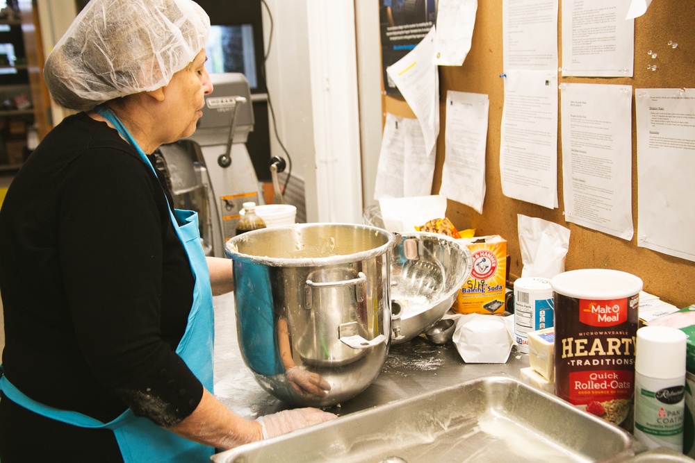 Adele La Fleur prepares and pans the Banana Nut Bread for the oven