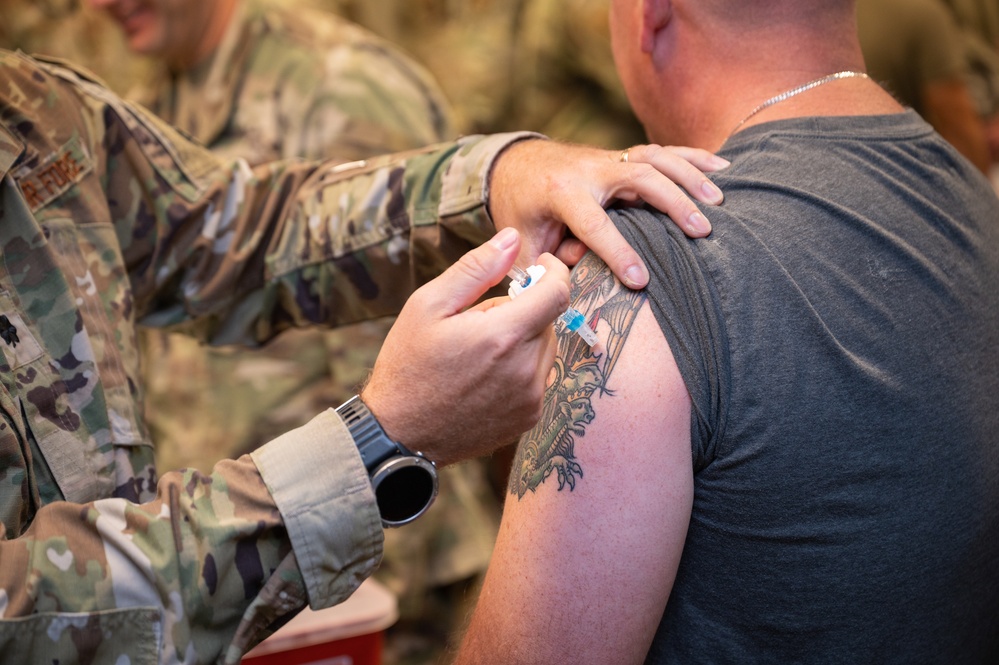 Photo of 116th Medical Group Airman administering flu vaccination to wing members