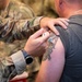 Photo of 116th Medical Group Airman administering flu vaccination to wing members